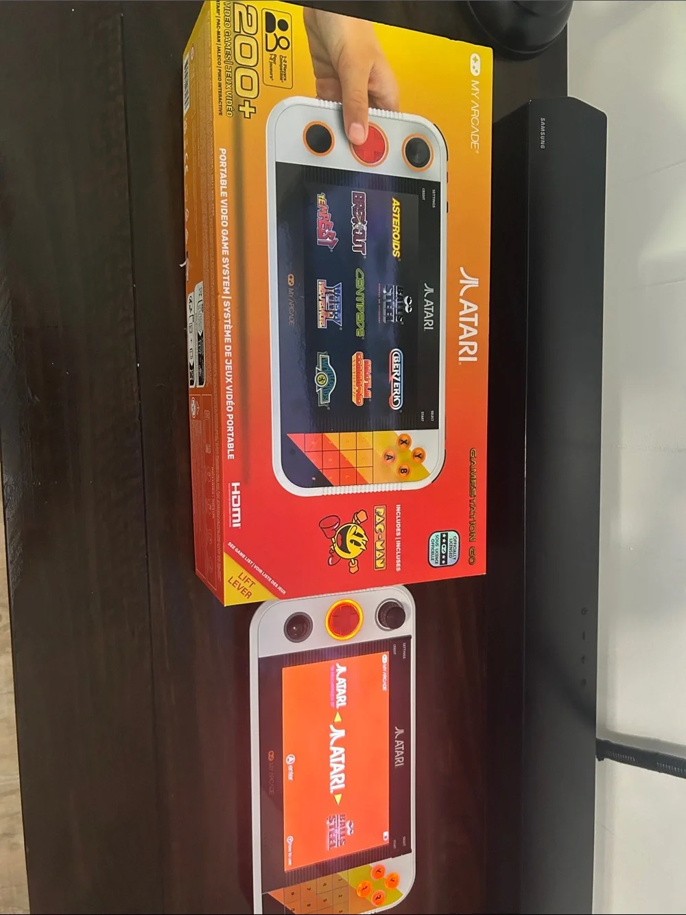 Atari Handheld Gaming Console in White and Orange